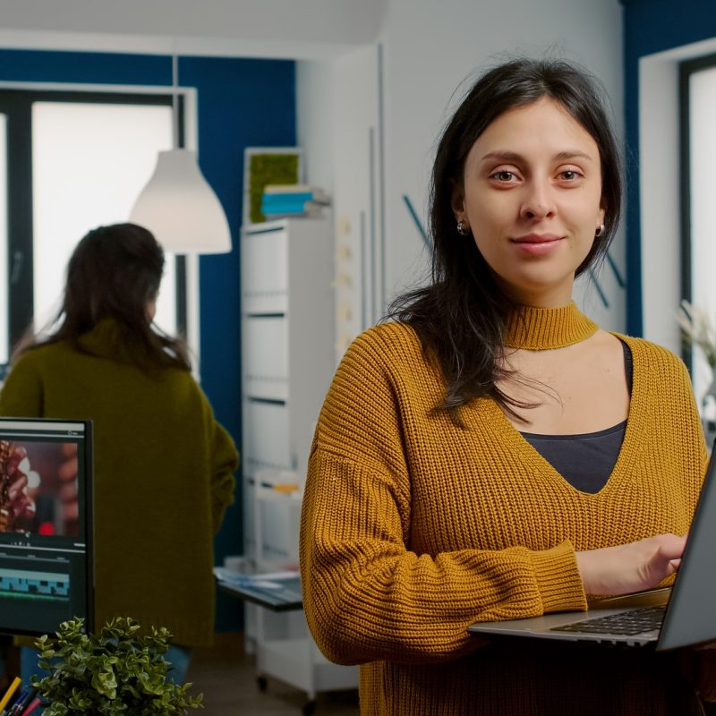 woman-retoucher-looking-at-camera-smiling-working-in-creative-media-agency.jpg